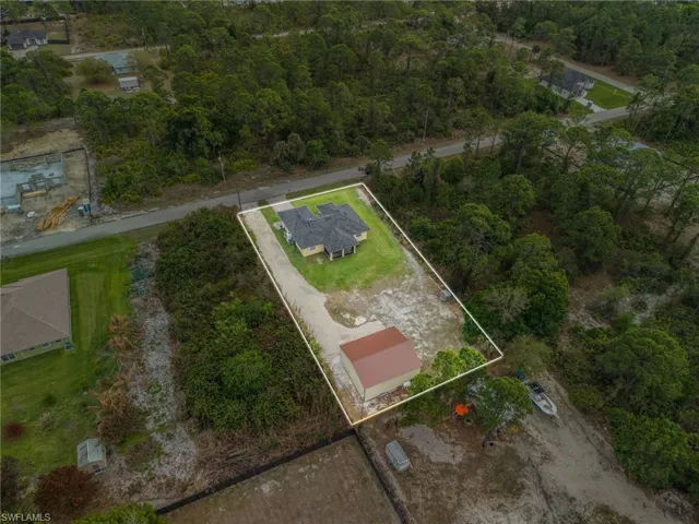 Aerial view of property and surrounding area with property parcel outlined