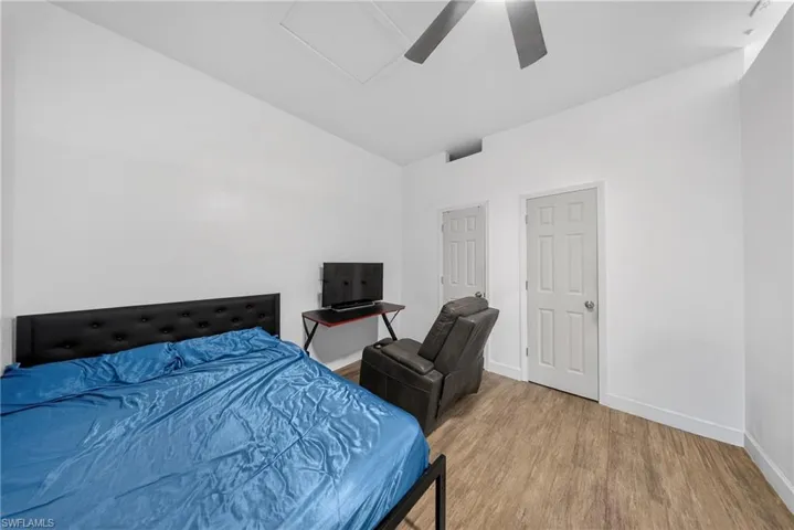 Bedroom with wood finished floors and a ceiling fan