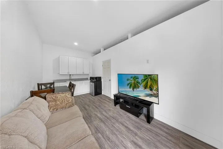 Living room featuring dark wood-style flooring