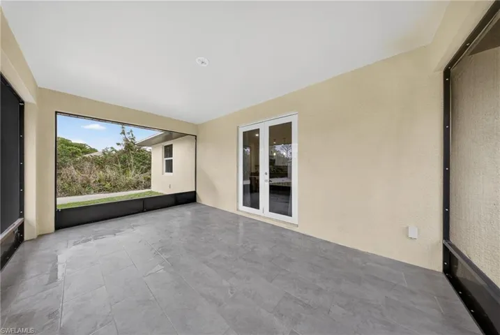 Unfurnished sunroom with french doors