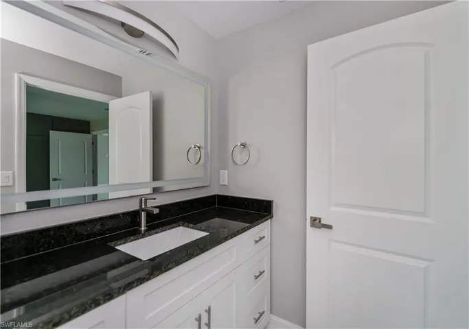 Bathroom with vanity and baseboards