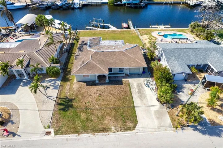 Birds eye view of property with a water view