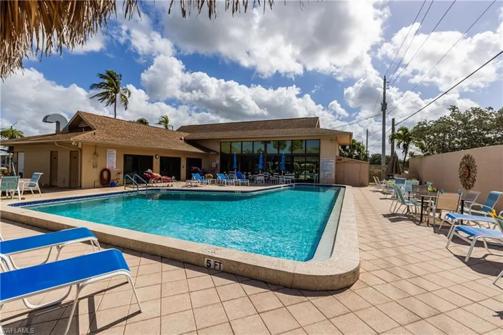 Pool with a patio and fence