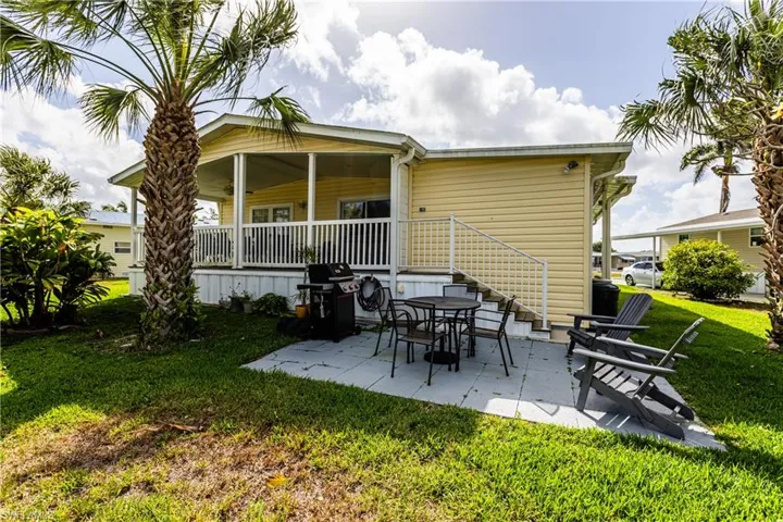 Back of house featuring a patio area and a lawn