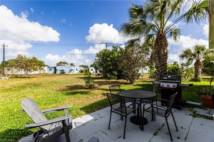 View of patio featuring a grill and outdoor dining space
