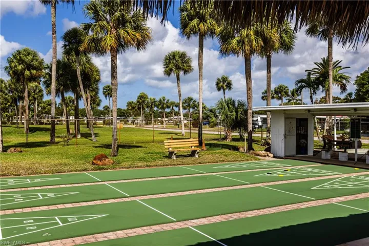 Surrounding community featuring a yard and shuffleboard