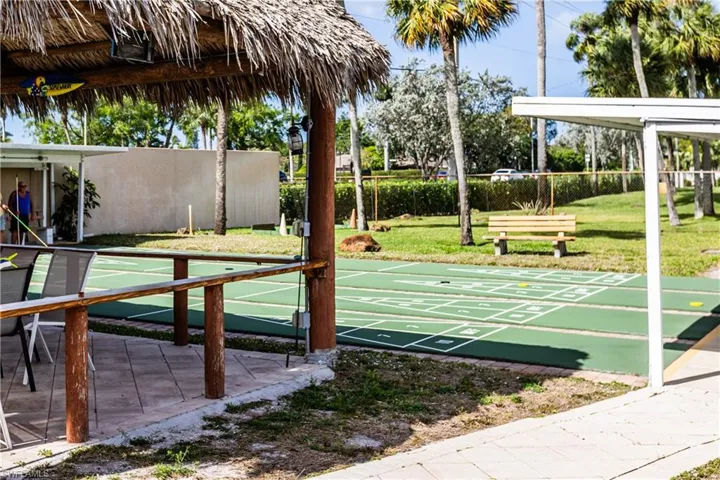 Surrounding community with a lawn and shuffleboard