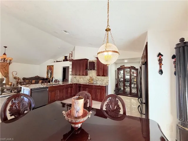 Dining room featuring lofted ceiling and a chandelier