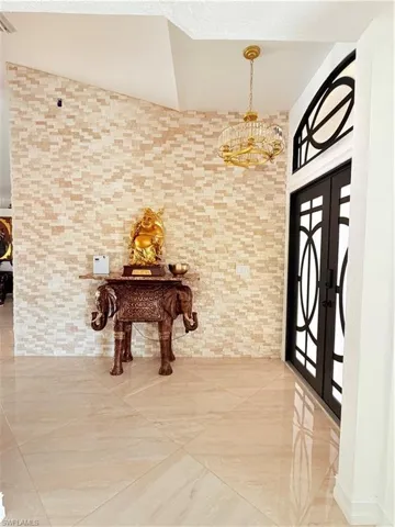 Foyer featuring french doors and suspended lighting