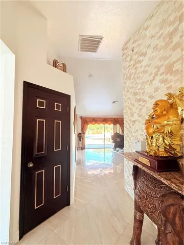 Hall featuring a high textured ceiling