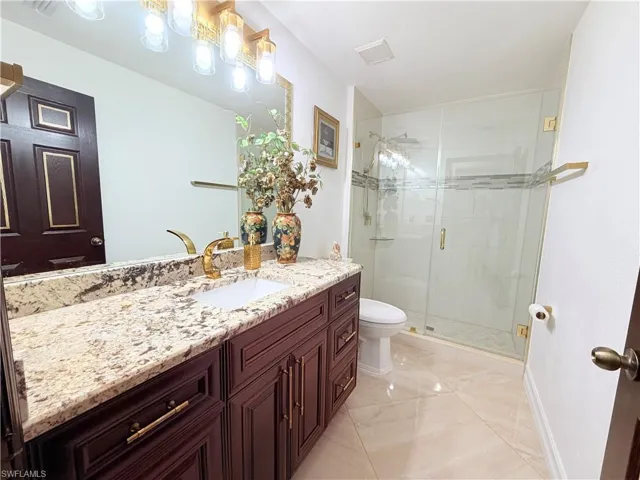 Full bathroom featuring vanity and a stall shower