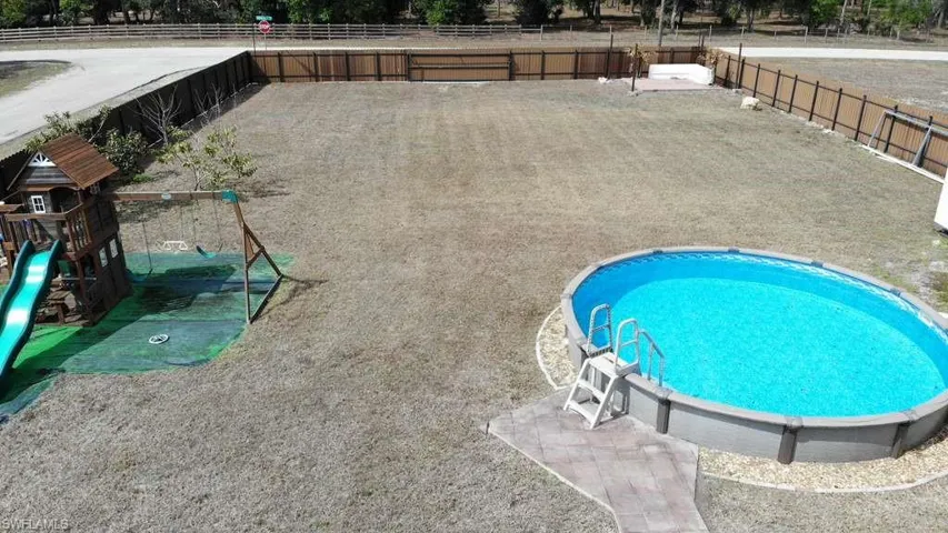 View of pool with a playground