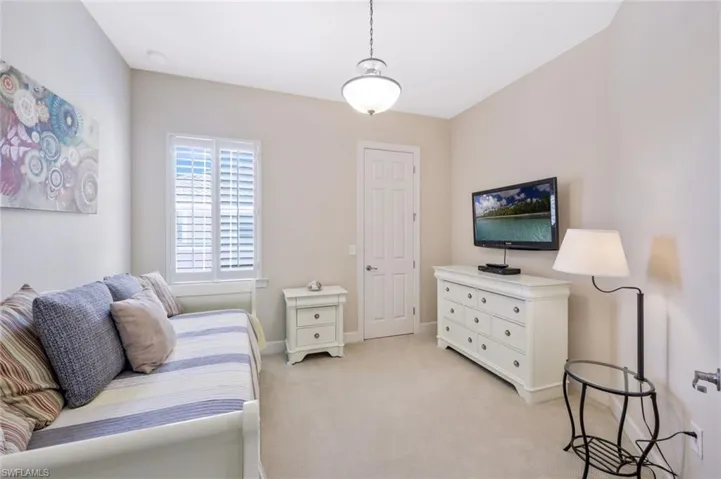 Bedroom with light carpet and baseboards