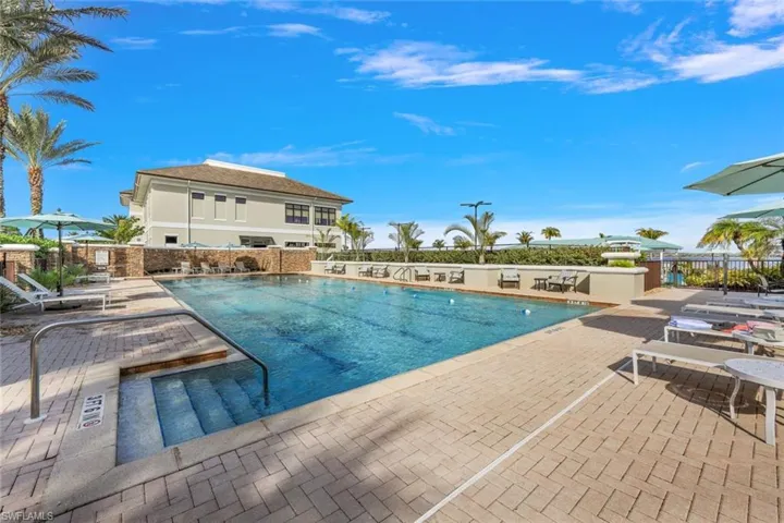 Community pool with a patio