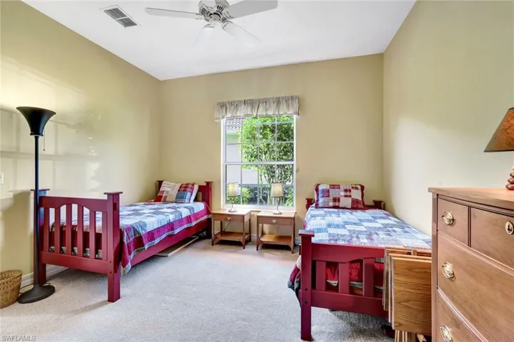 Carpeted bedroom featuring a walk-in closet