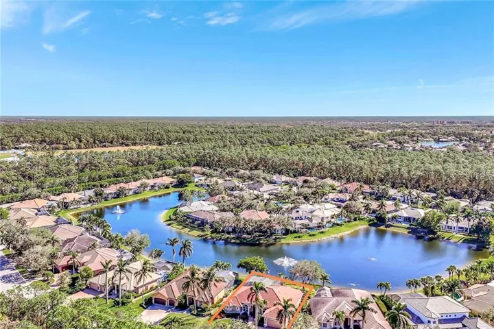 Birds eye view of property with a water view.