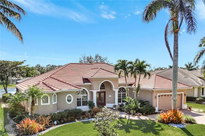 Mediterranean house with a 2 car garage and a beautiful front yard