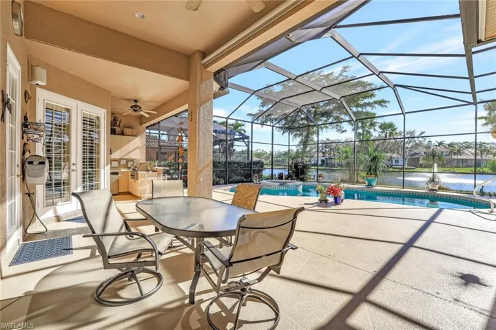 Spectacular South facing water view with a covered patio, a heated swimming pool with hot tub all within a screened enclosed lanai