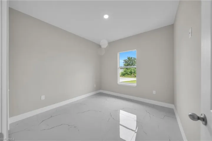 Empty room with baseboards and marble finish floors
