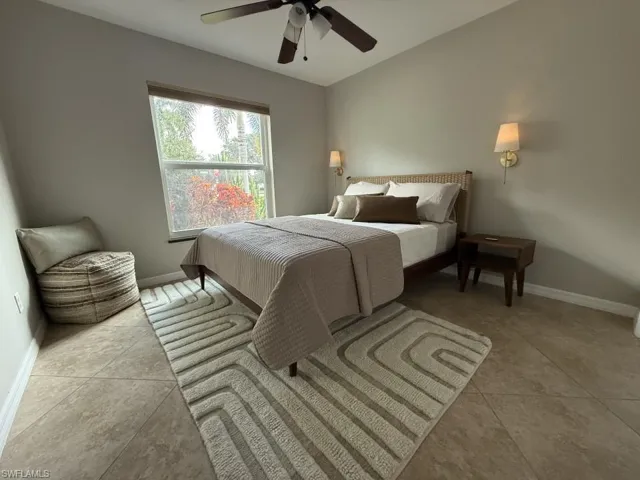 Guest Bedroom with ceiling fan and light tile patterned floors