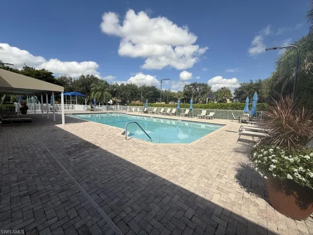 Community pool with a patio