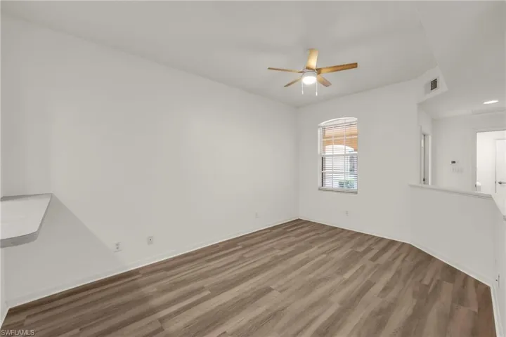 Unfurnished room featuring wood finished floors and ceiling fan