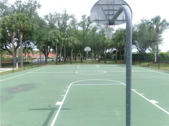 View of basketball court with fence and community basketball court