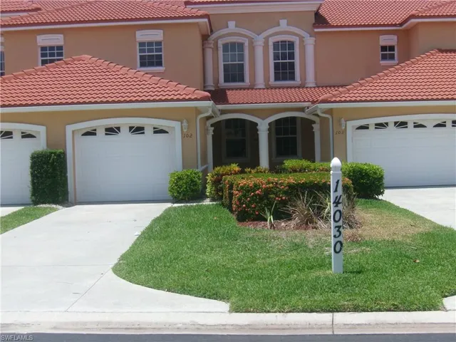 Mediterranean / spanish house with concrete driveway, an attached garage, and stucco siding