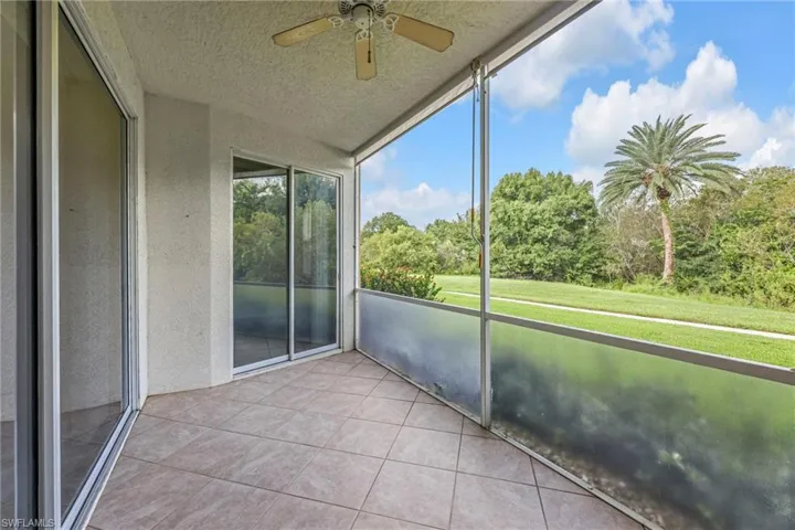 Unfurnished sunroom with ceiling fan