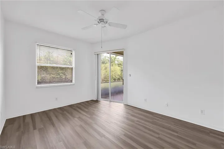 Empty room with wood finished floors and ceiling fan