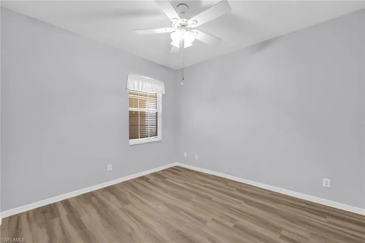 Unfurnished room featuring wood finished floors and ceiling fan
