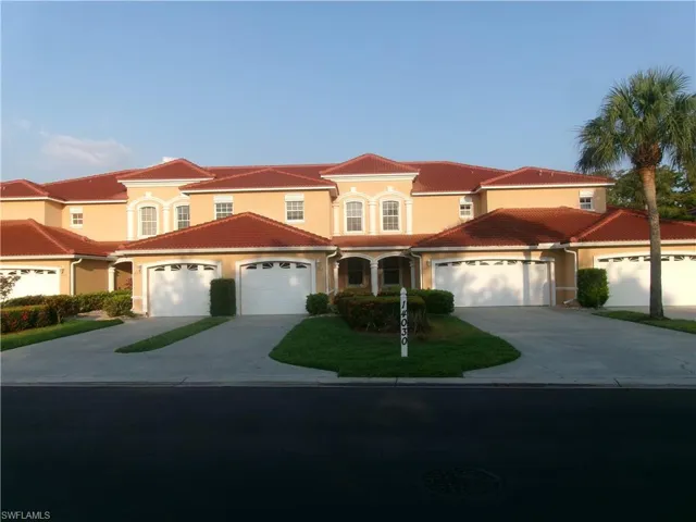 Mediterranean / spanish-style house with stucco siding, driveway, and a tile roof