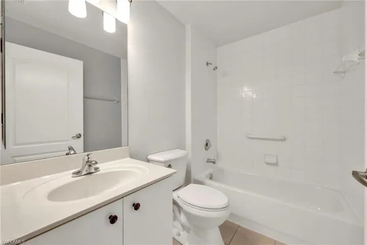 Bathroom with tile patterned floors, vanity, and bathtub / shower combination