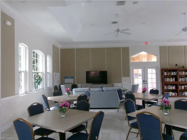 Dining room with ceiling fan, french doors, light tile patterned floors, and ornamental molding