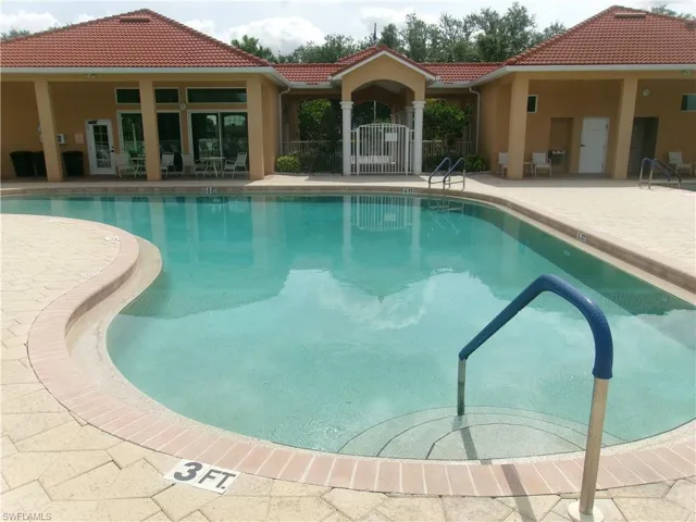 Community pool with a patio