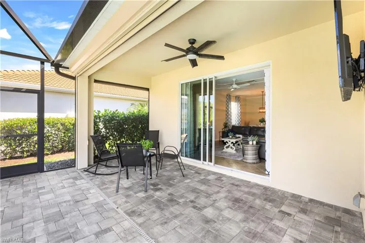View of patio with glass enclosure and ceiling fan