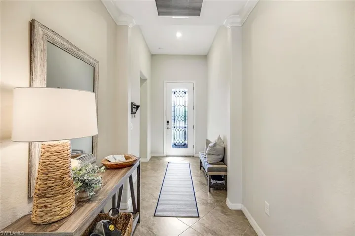 Entryway featuring baseboards, visible vents, and light tile patterned flooring