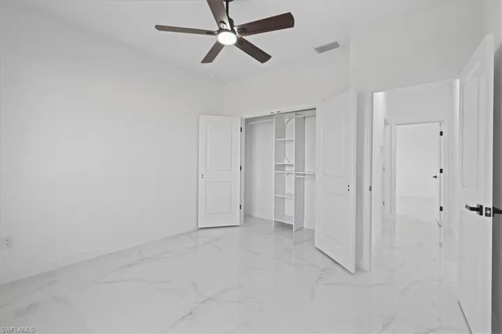 another view of Unfurnished 3rd bedroom featuring a ceiling fan, a closet, and ceramic flooring