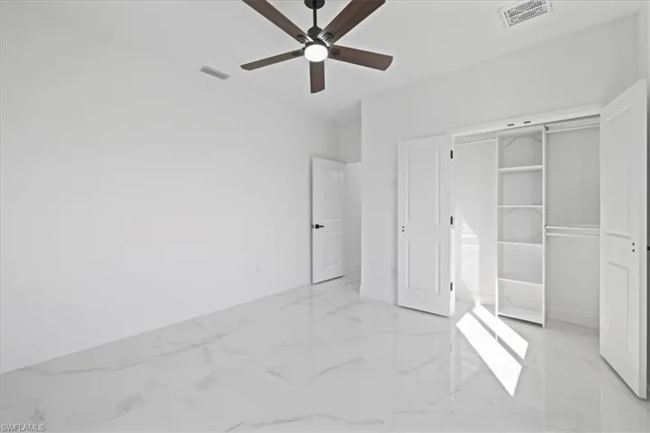 Unfurnished 2nd bedroom-another view featuring ceiling fan, ceramic flooring, and a closet