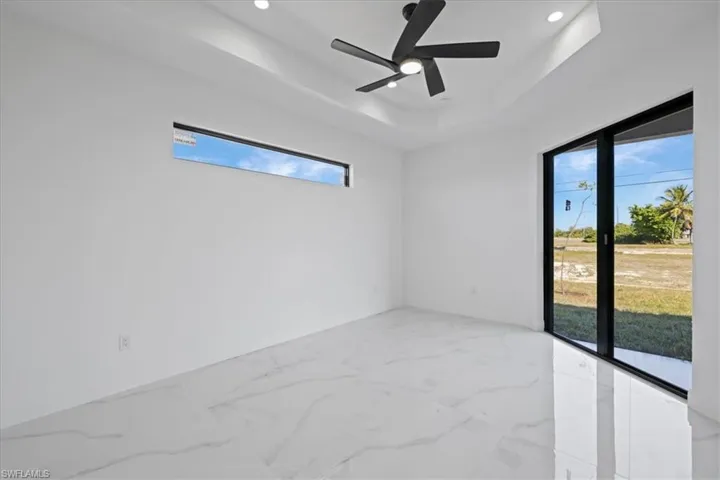 another view of the primary room featuring picture window and sliding doors to the patio