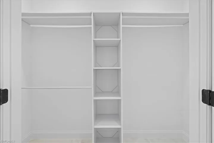 View of one of the two walking closets in Primary Bedroom.