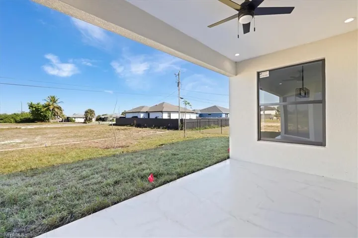 View of patio / terrace featuring a ceiling fan and a residential view