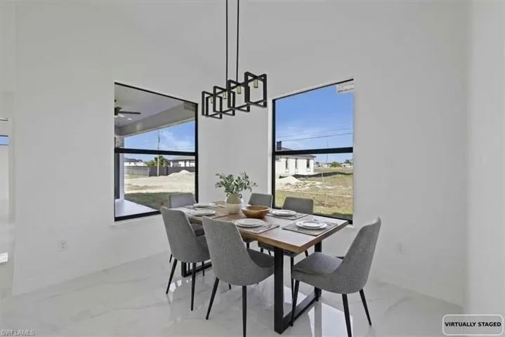 Photo Staged. Dining room with modern light features and healthy amount of natural light