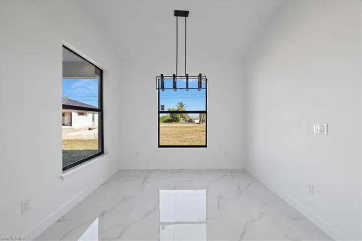 Unfurnished dining area with high ceiling and ceramic floors