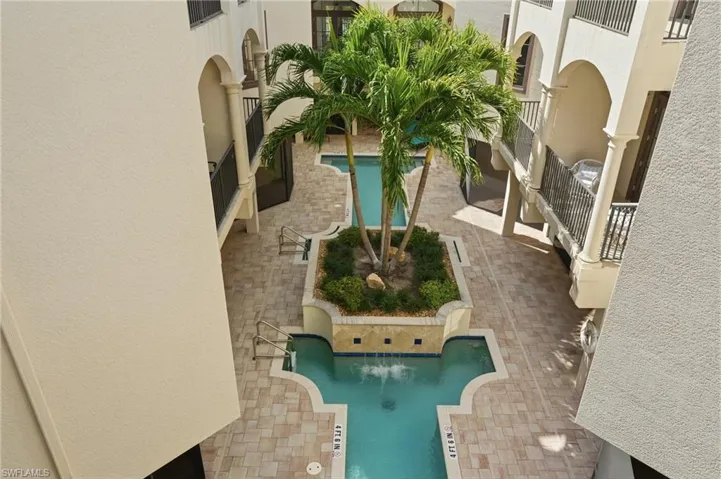 Community pool featuring a patio area and a balcony