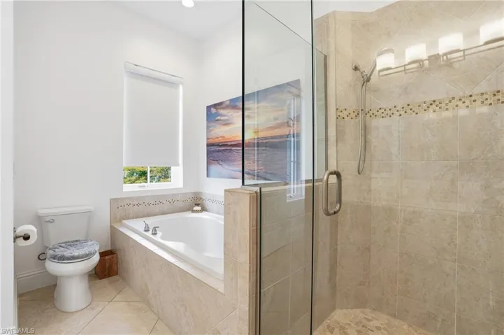 Bathroom with a shower stall, tile patterned floors, a bath, and recessed lighting