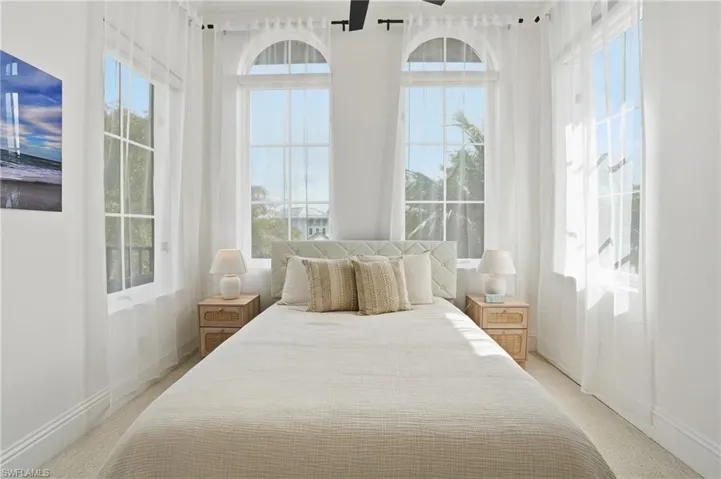 Bedroom featuring light colored carpet and baseboards