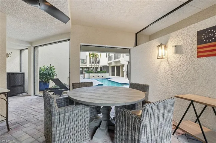 View of patio / terrace featuring outdoor dining area and an outdoor pool