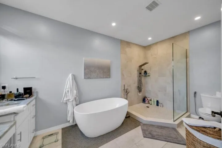 Master bathroom with tub and shower. Also, large vanity area.
