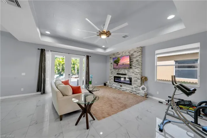 View of living room and gorgeous French doors that lead to outside oasis